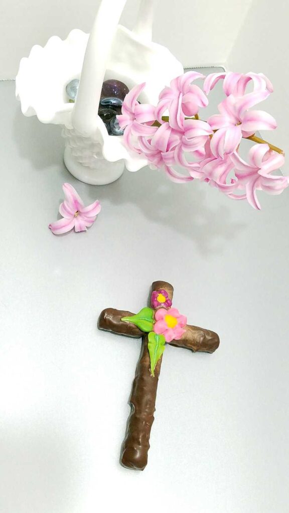 dark chocolate covered cross pretzel with pink hyacinths