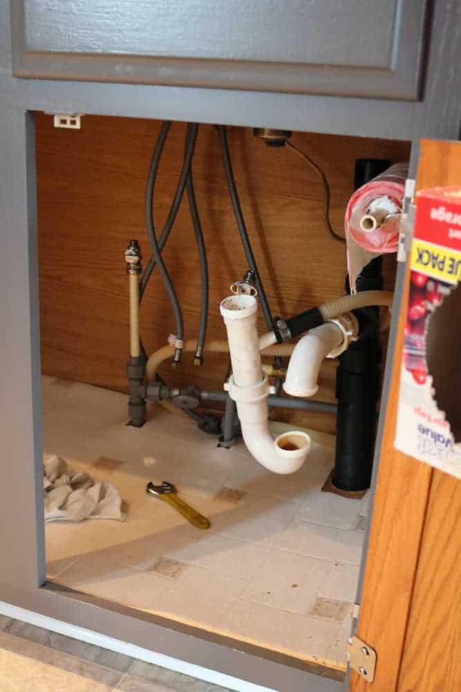 underneath kitchen sink drain pipes