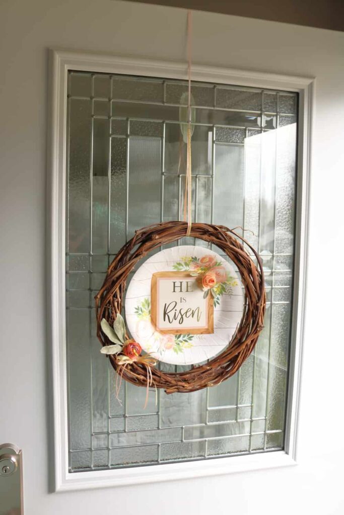 He is Risen Easter wreath hanging from door