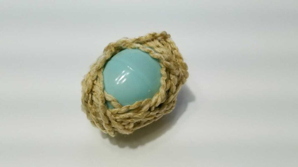 yarn wrapped around a plastic egg