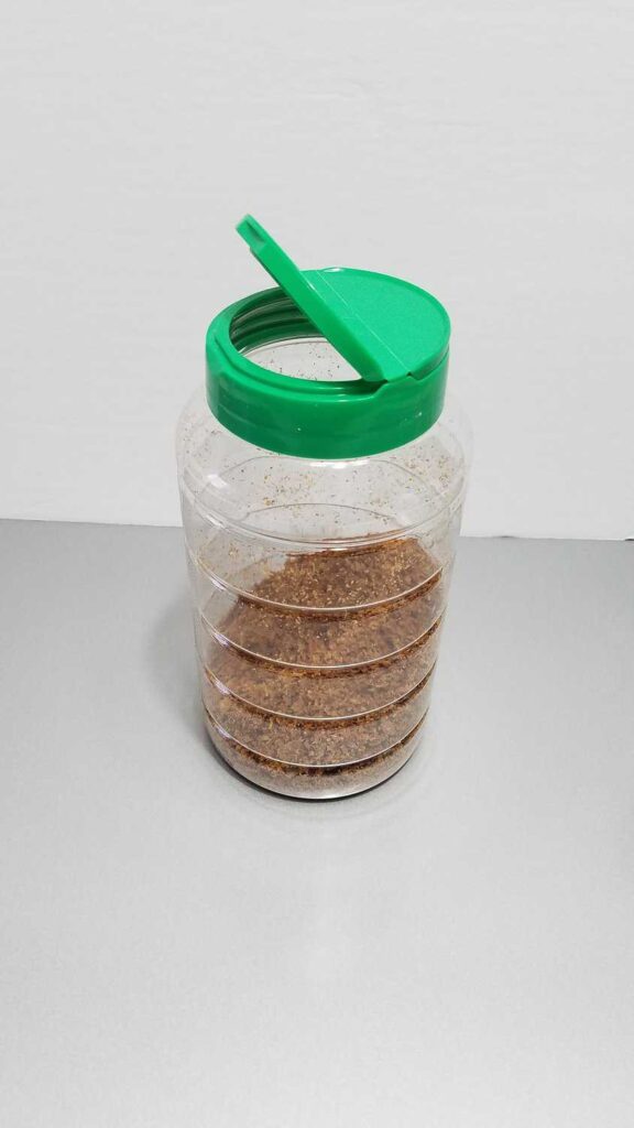 bacon bits in a clear container with a green lid