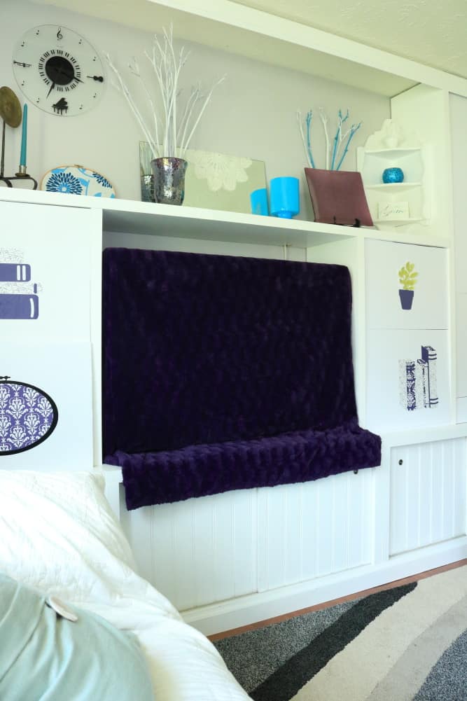 tv decor with purple throw dust cover