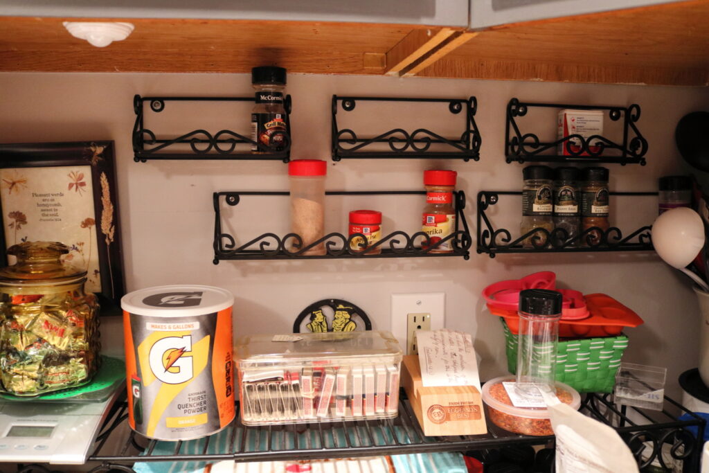 almost empty spice racks on kitchen wall