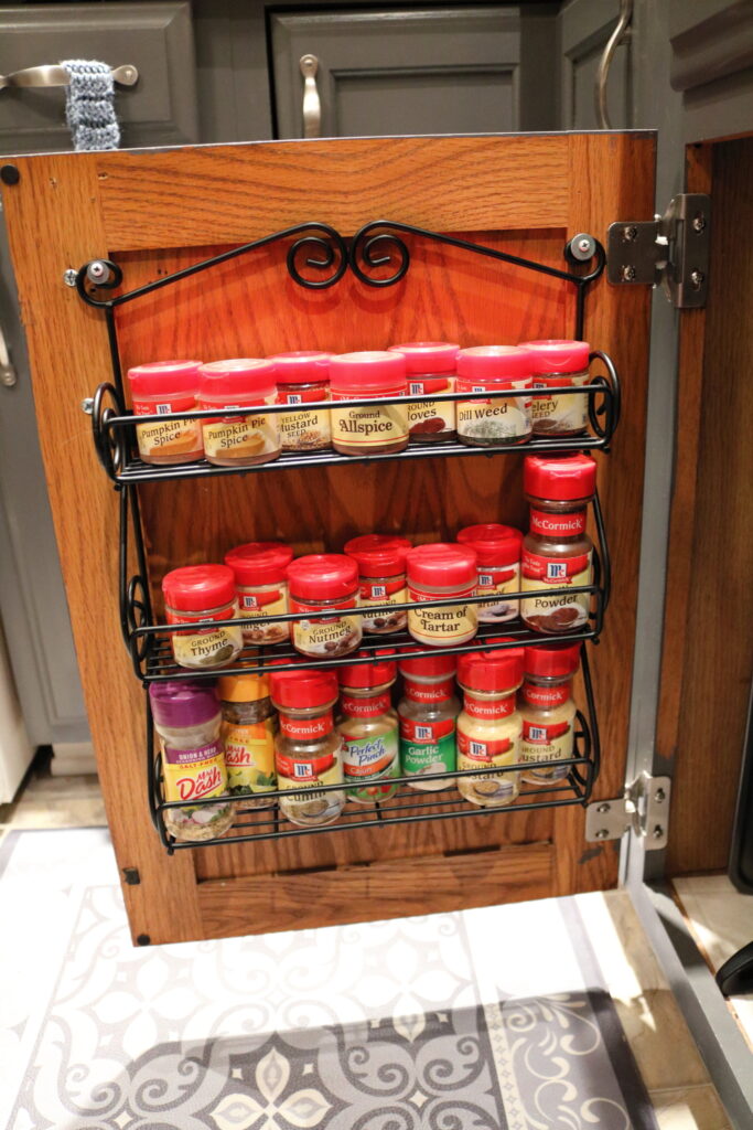 3 shelf spice rack full of spices