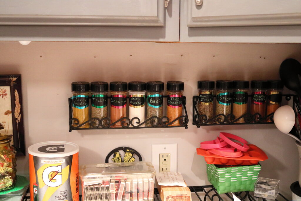 organized spice racks on wall shelf