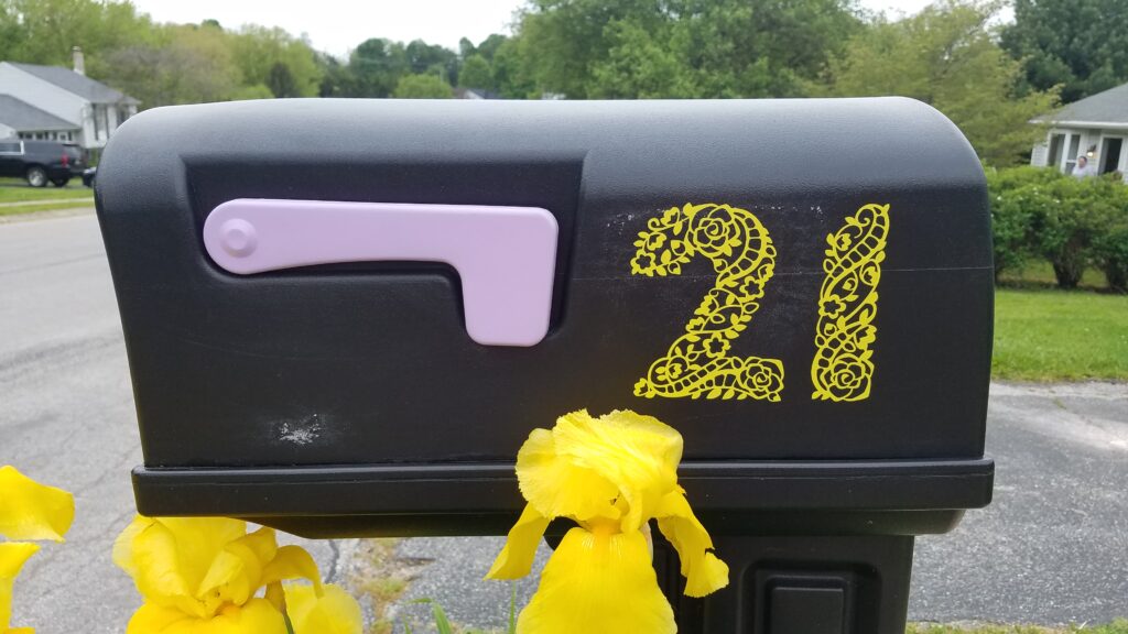 closer view of yellow mailbox numbers 21