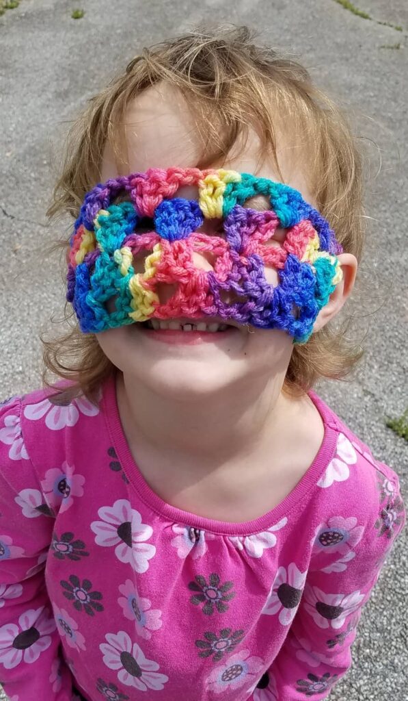 colorful towel holder worn over eyes as a sleep mask