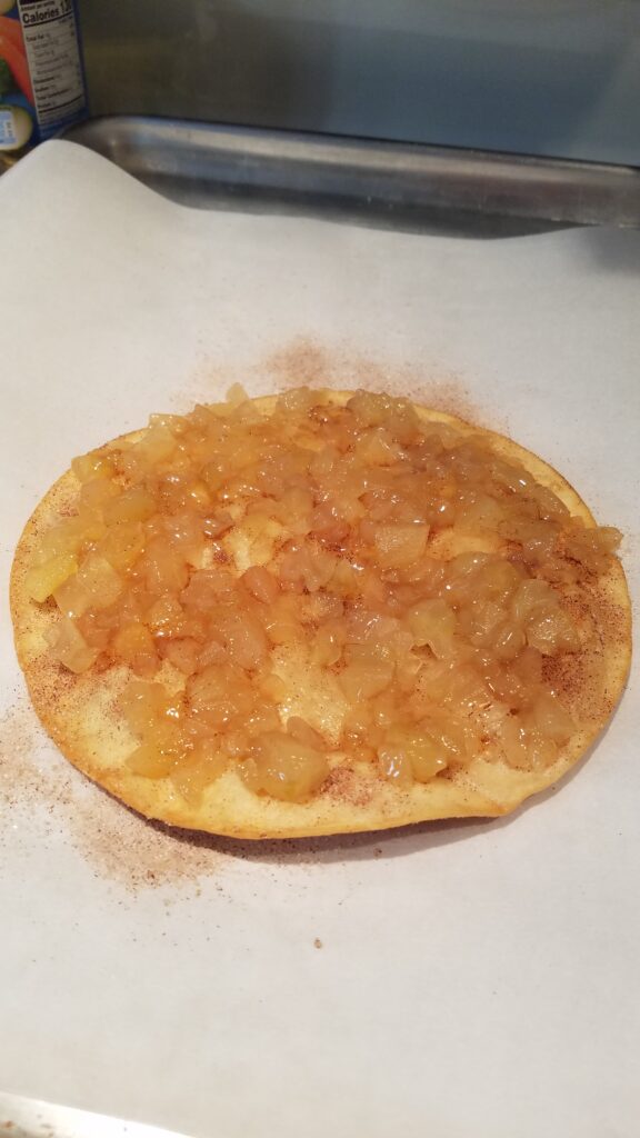 apple pie filling spread on a cinnamon sugar flour tortilla