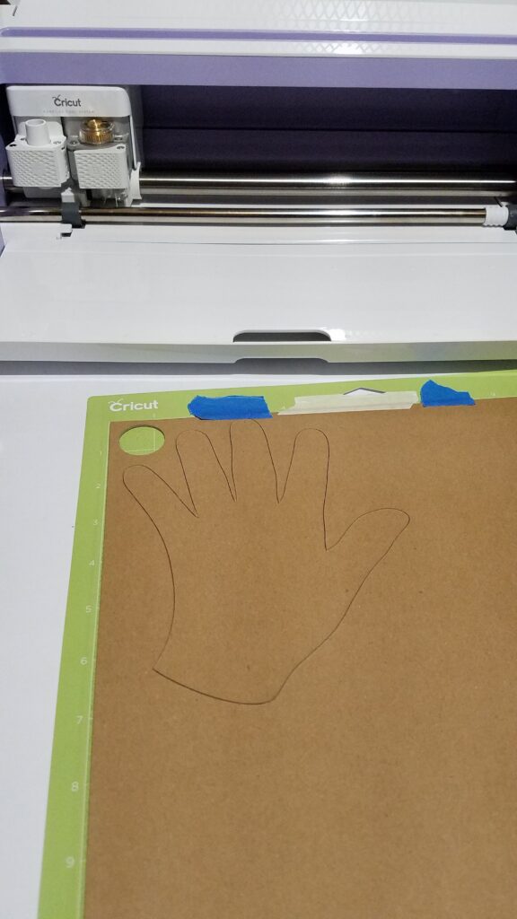 chipboard hand on a cricut mat