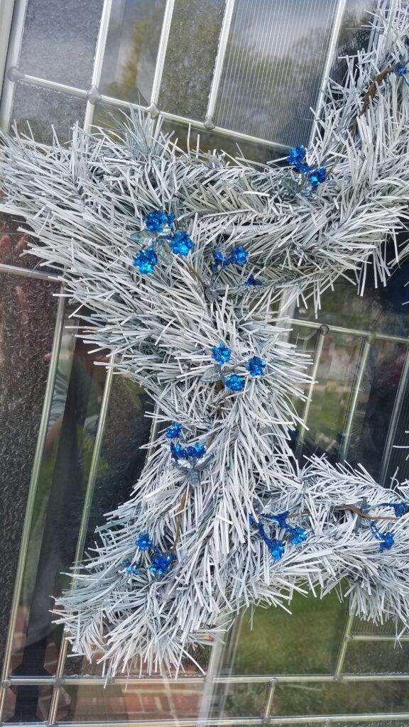 closeup of sparkly blue flower accents on star shaped wreath