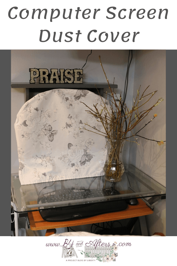 gray and white floral fabric over a computer screen at a desk