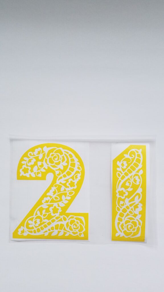 yellow vinyl number 21 cut out with floral pattern in numbers