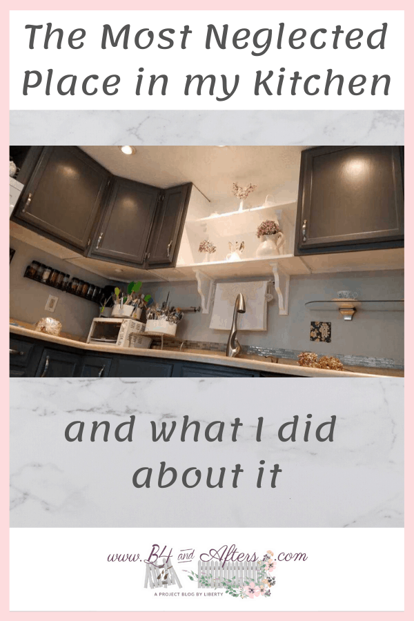 picture of upper gray kitchen cabinets from an angle close to the floor