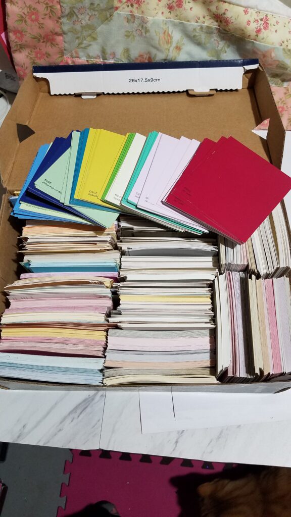 box of various colors of paint chip sample cards