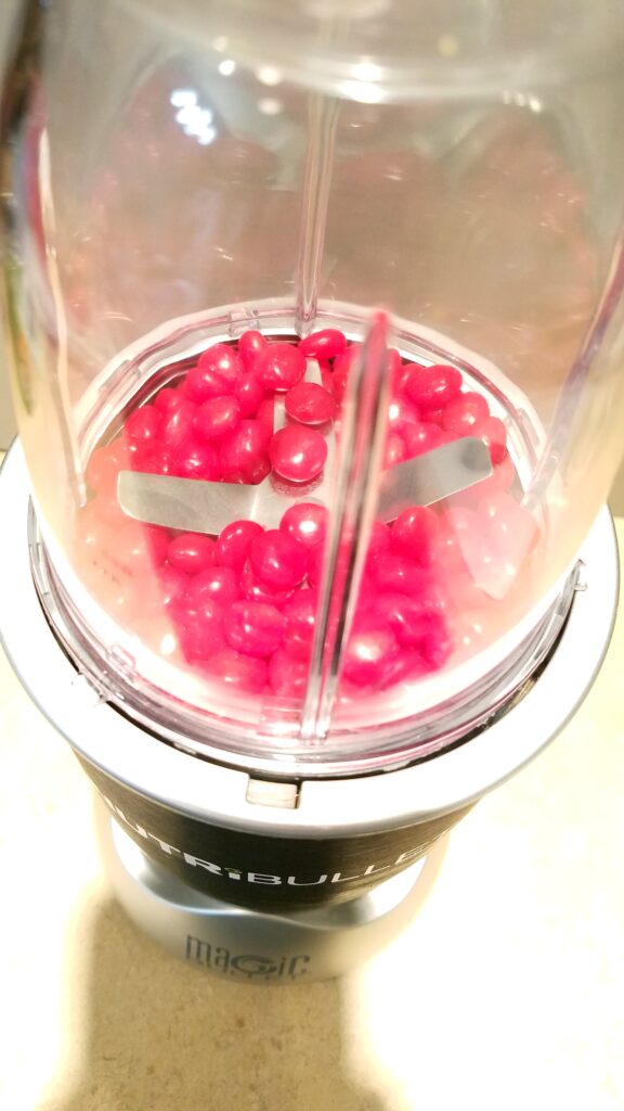 closeup of red hot candies in nutribullet blender