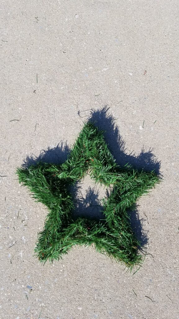 5 pointed star shaped wreath with faux greenery