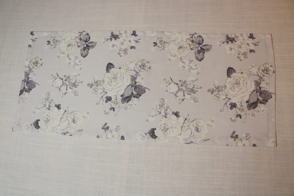 gray and white flowered table runner