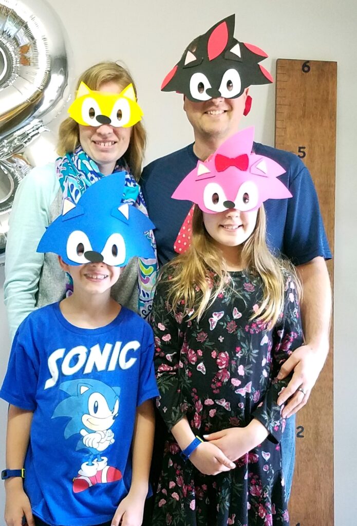 family of four wearing Sonic the Hedgehog face masks