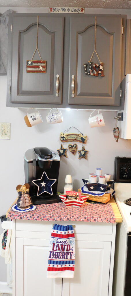 Kitchen coffee station decorated for the fourth of July with wooden elements