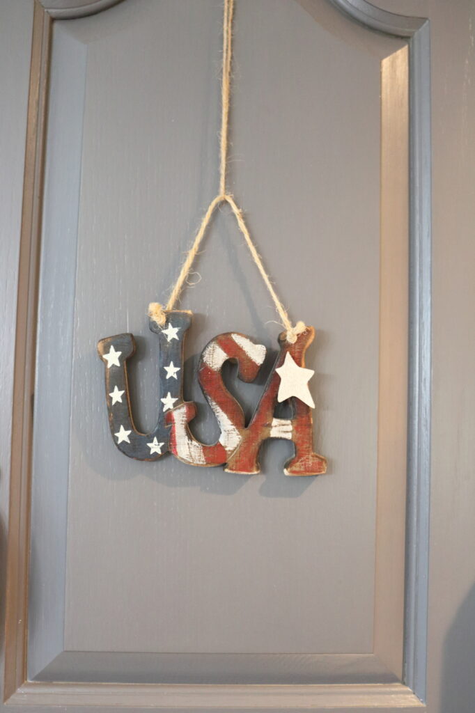 wooden USA ornament hung by jute string
