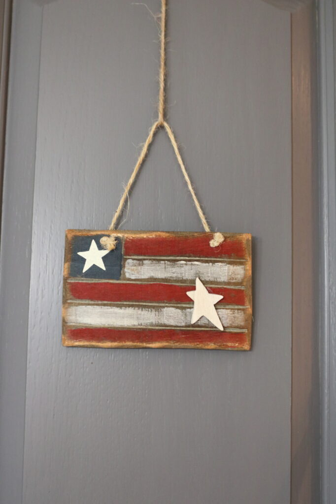 wooden flag ornament hung with jute string