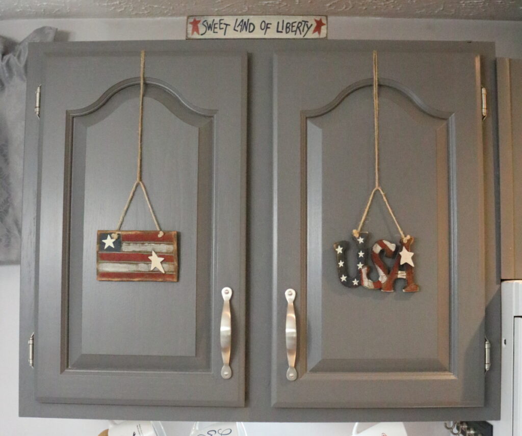 wooden patriotic ornaments on kitchen cupboards