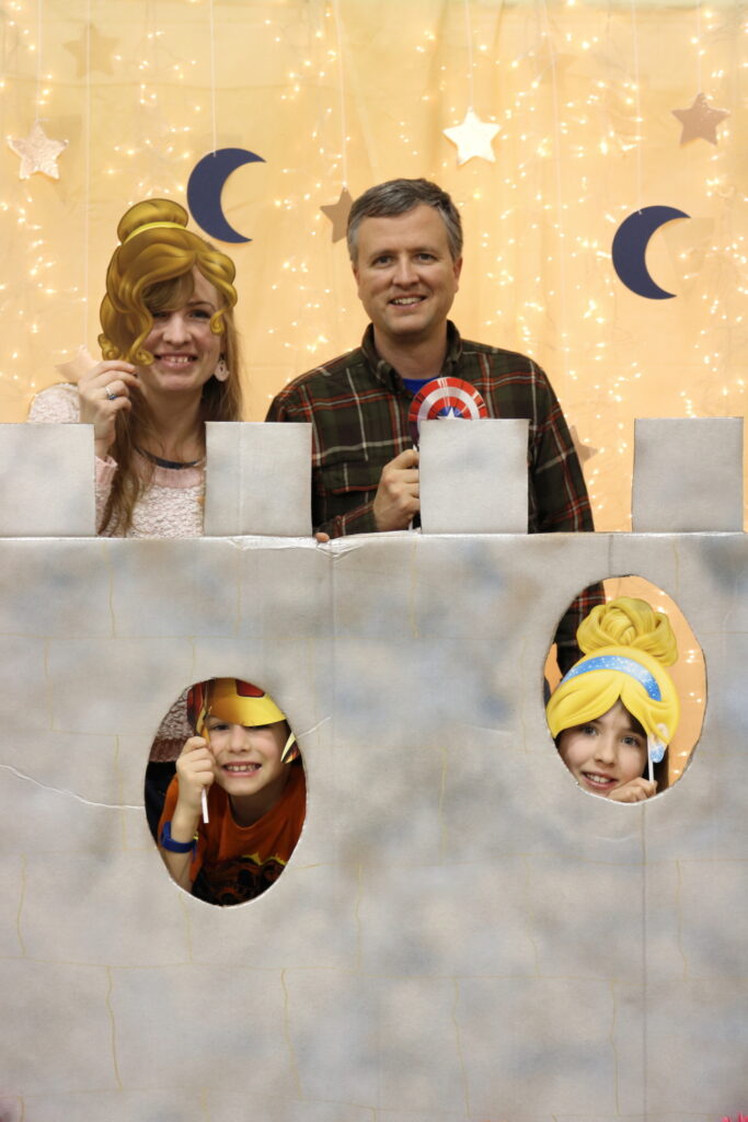 family of four photographed with castle, stars, and moons photo booth