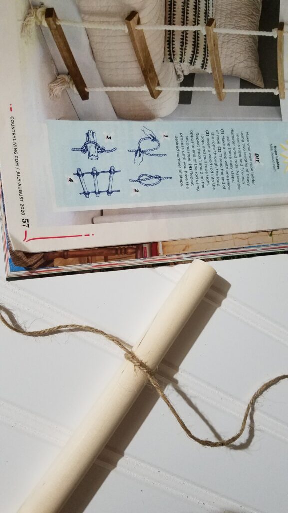 jute rope tied around a dowel rod, next to a magazine picture of a rope ladder