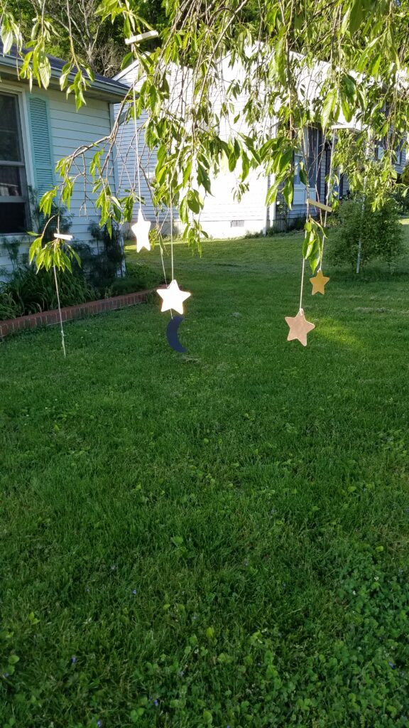 moons and stars hanging from tree branches