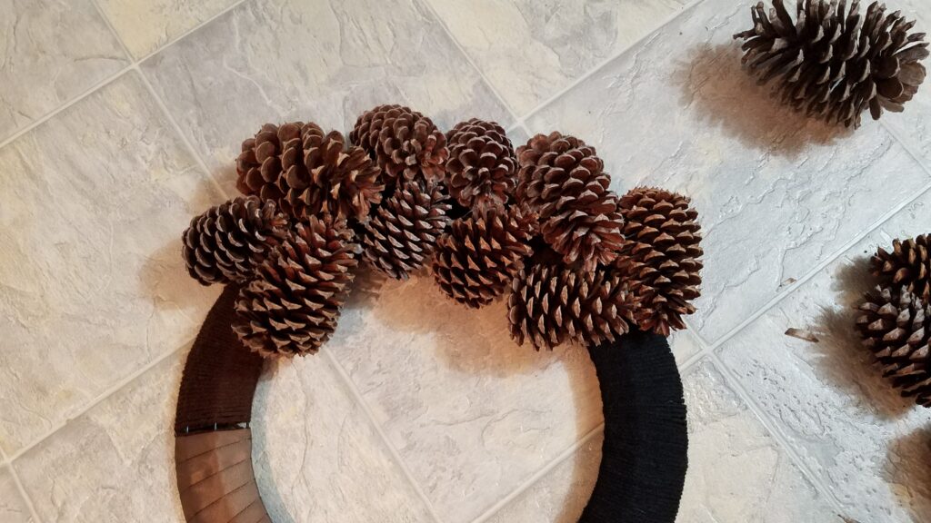 pine cones glued to part of a wreath frame