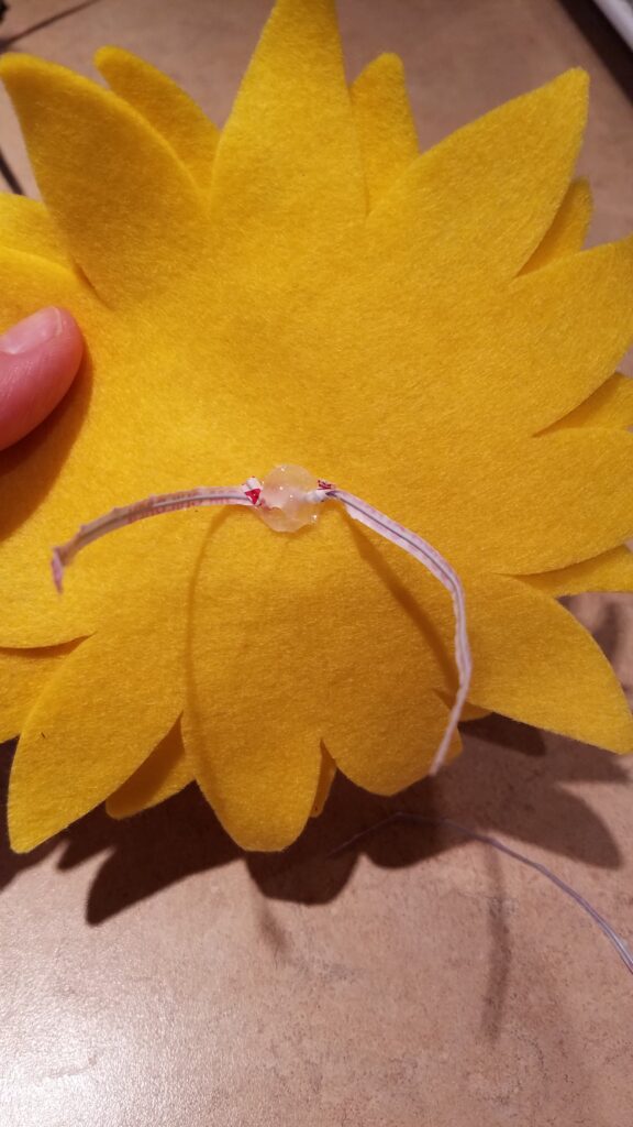 twisty ties hot glued to back of felt sunflower