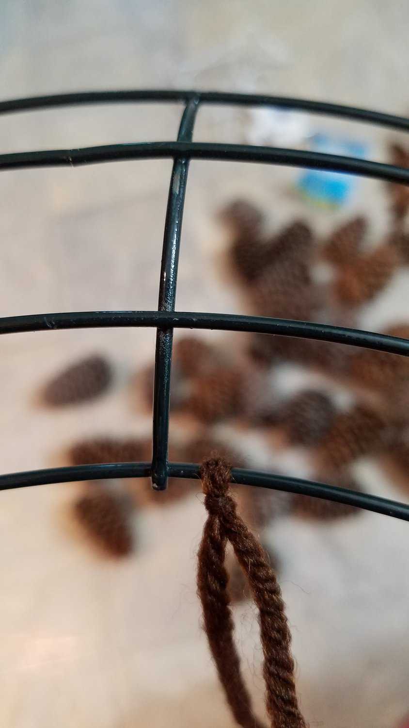 brown yarn tied to wire wreath frame