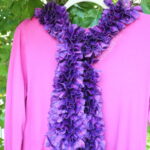 purple and pink scarf tied on a pink shirt
