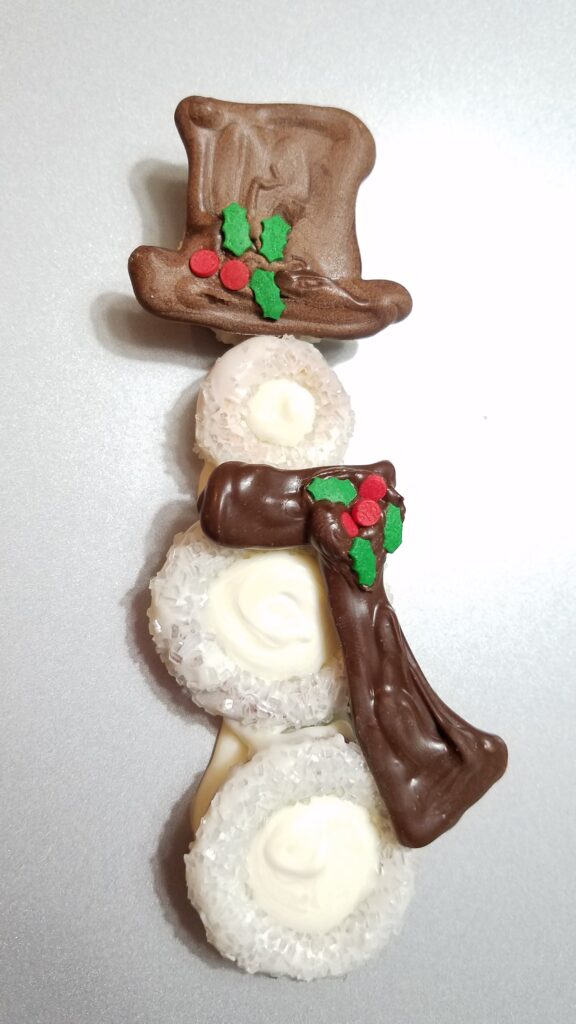 chocolate covered snowman with dark cholate scarf and hat