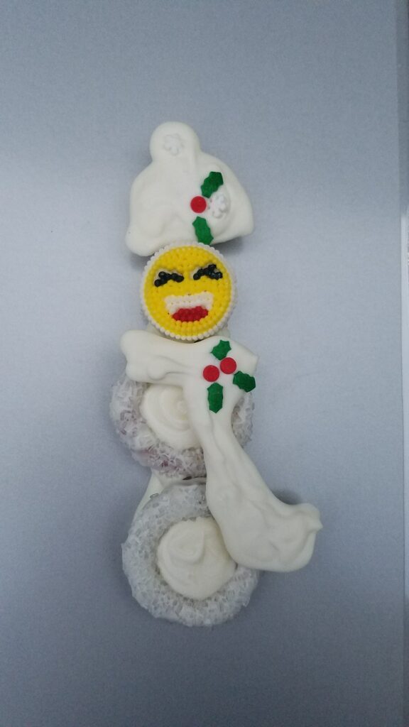 emoji face of snowman chocolate covered pretzel