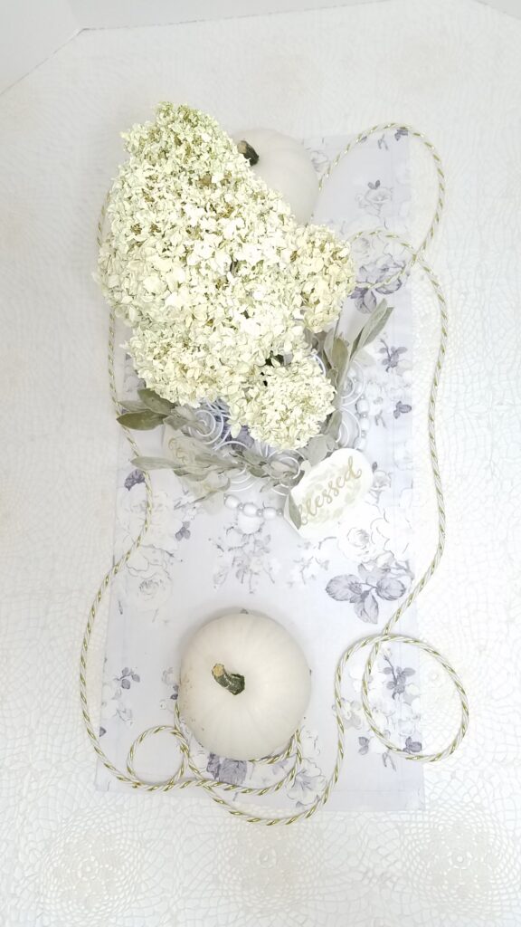 white pumpkin centerpiece with dried white hydrangea flowers