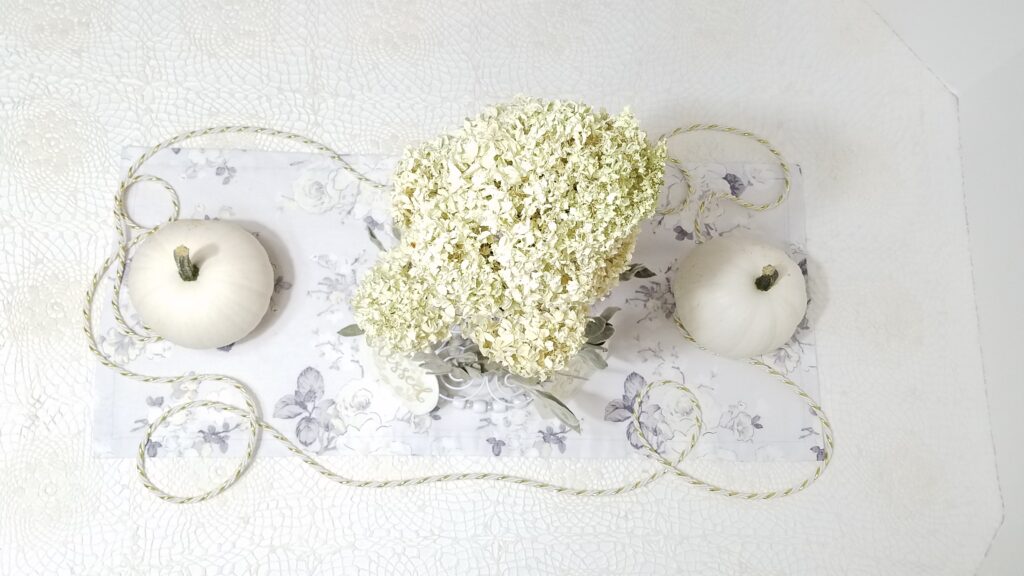 ariel view of white pumpkin centerpiece and hyrandeas