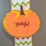 felt pumpkin on a ribbon on a cabinet door