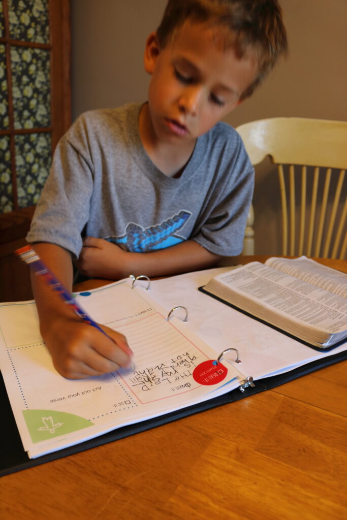 boy writing in notebook