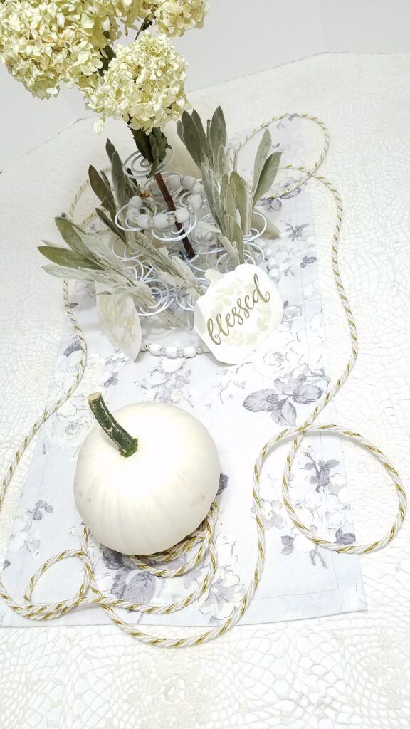 white pumpkin centerpiece with dried flowers