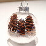 3 mini pinecones in a clear ornament