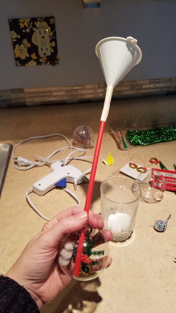 mini funnel taped to a straw