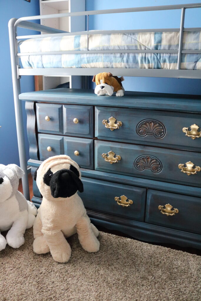 blue dresser with stuffed dogs