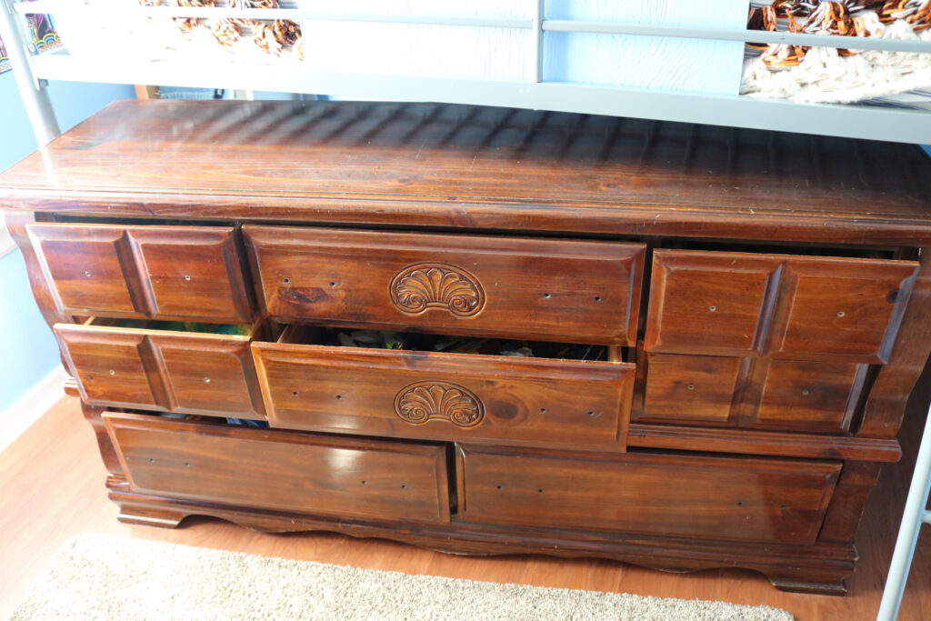 brown dresser with hardware off of it