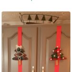 fabric Christmas trees on red ribbon on gray cabinet doors