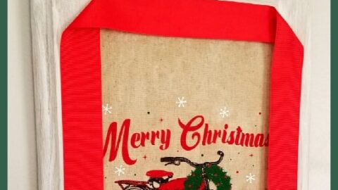 Cupboard door with a fabric burlap bag sign and red ribbon