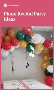 red, green, white, and gold balloon garland on the wall with music notes