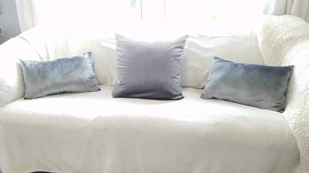 silver velvet pillows on couch