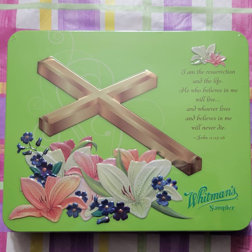 Green Whitman's chocolate tin with cross and Bible verse on it