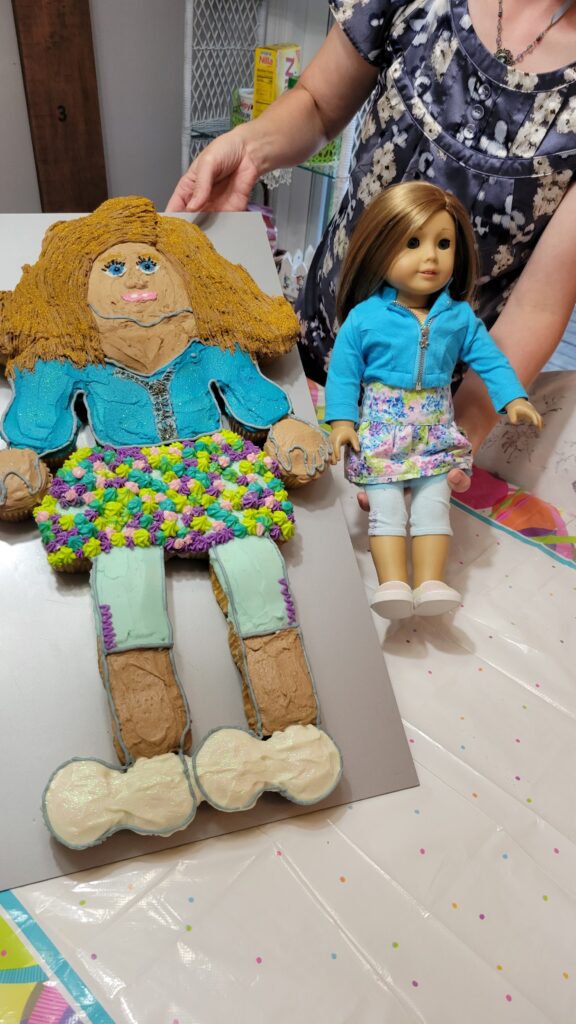 Showing cake and doll side by side